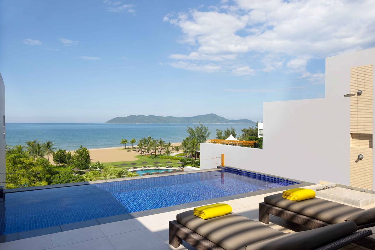 A rooftop infinity pool with a view of the beach and ocean.