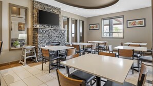 A restaurant with stone walls, multiple tables, and chairs. - Best Western Estevan Inn & Suites (Estevan)
