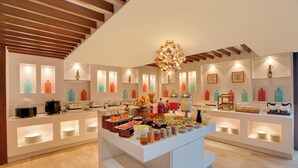 A modern breakfast buffet with a variety of food items and a central serving area. - Lemon Tree Resort, Mussoorie (Dehradun)