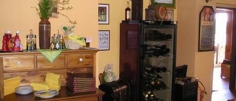 A kitchen with wooden cabinets, a refrigerator, and a clock on the wall.