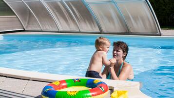 Relax by the pool, where a clear water surface and comfortable seating area await.