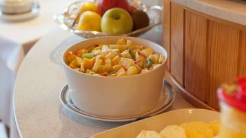 A bowl of fruit salad on a kitchen counter.