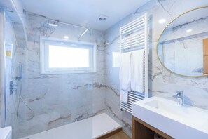 Bathtub, designer toiletries, hair dryer, bidet