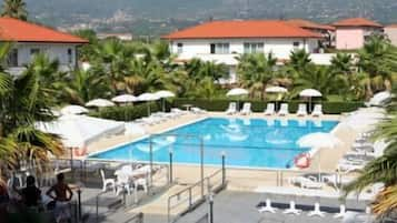 Una piscina al aire libre, sombrillas