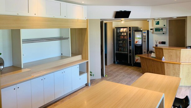 A modern hotel room with a kitchenette, a seating area, and a minibar. - My KB Hotel Montélimar (Saulce-sur-Rhone)