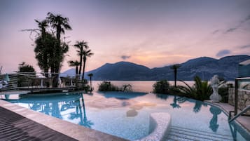 Una piscina al aire libre de temporada, sombrillas