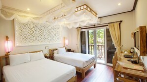 A hotel room with two beds, a wooden desk, a patterned wall, and a balcony with curtains. - Hoi An Pho Library Hotel (Da Nang)