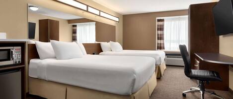 A hotel room with two beds, a desk, a chair, a television, and a microwave.