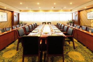 A conference room with a long table, multiple chairs, and a carpeted floor. - Fuling Hotel (Chongqing)