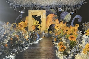Un arreglo floral con un camino que lleva a un escenario.