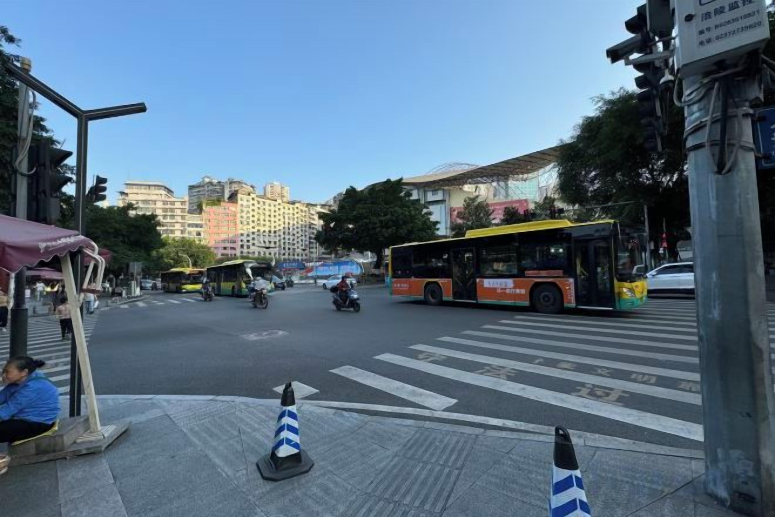 Una intersección con parada de autobús y paso de peatones.