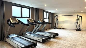 A fitness room with treadmills and a weight machine.