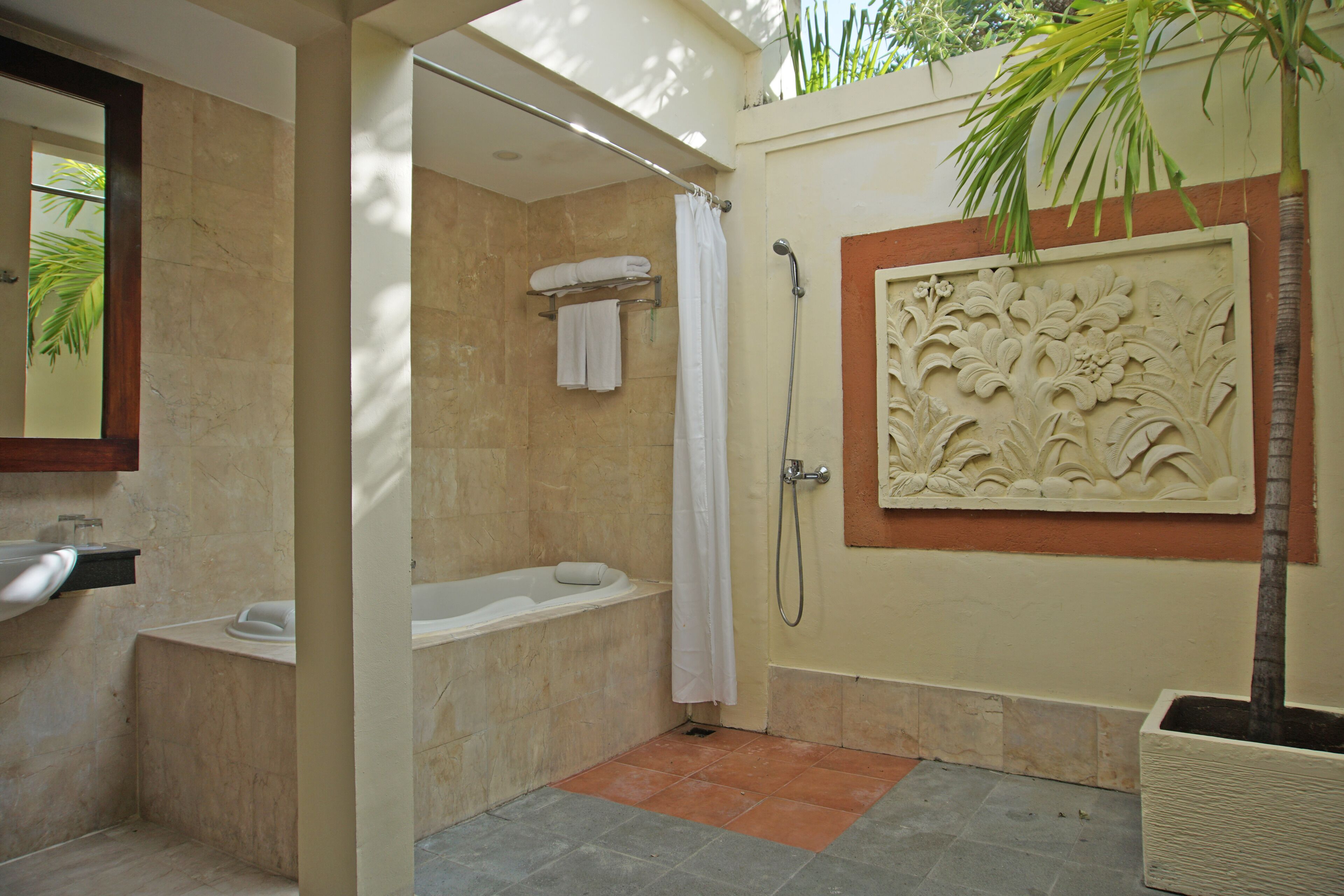 A bathroom with a bathtub, shower, and a sink.