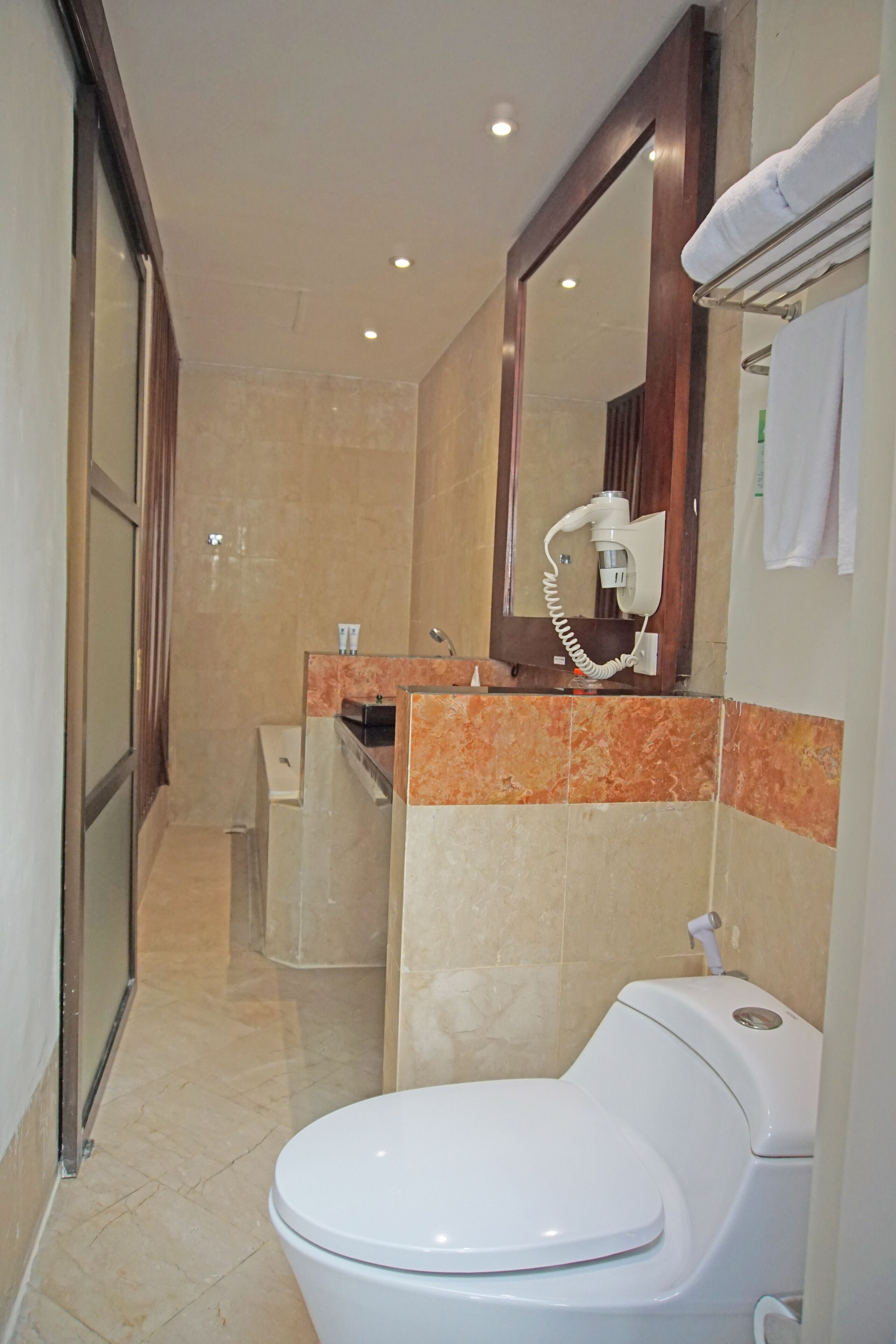 A modern bathroom with a toilet, sink, and shower.