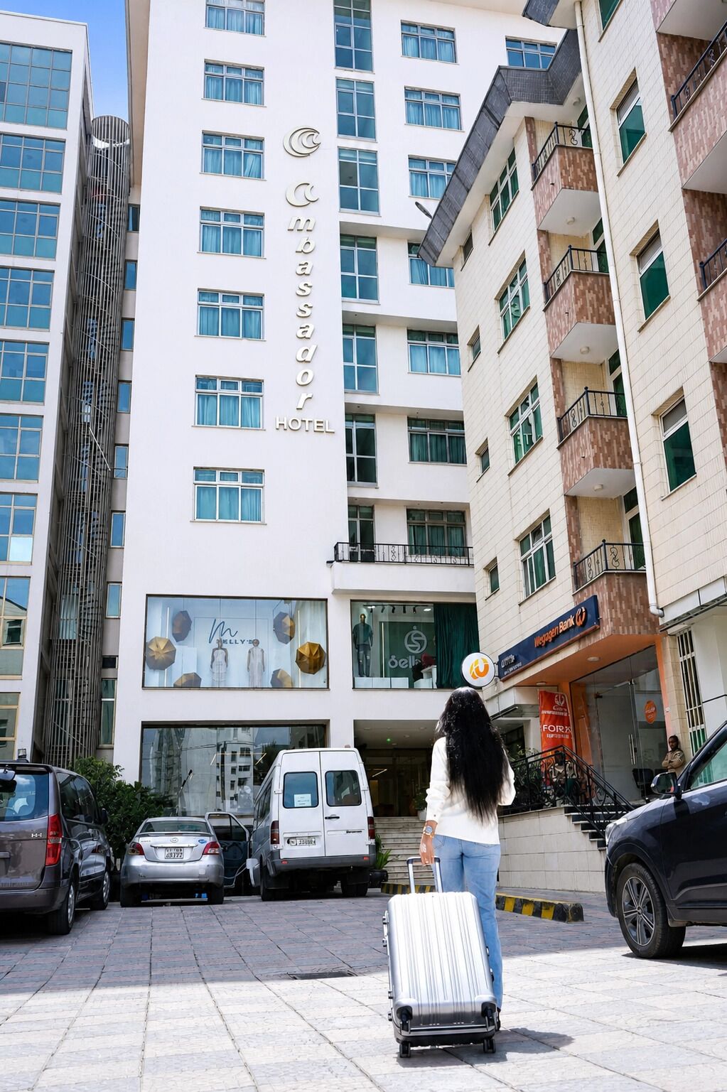 A hotel with a modern facade, multiple floors, and a visible entrance.