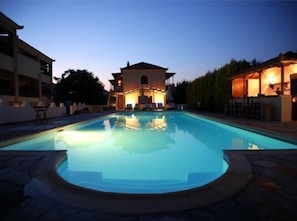 A swimming pool with a building in the background.