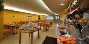 Enjoy a group dining experience in our spacious dining area, featuring a buffet setup and comfortable seating for gatherings.