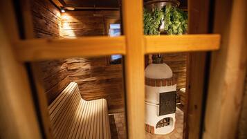 A wooden interior with a bench, a fireplace, and a hanging plant.