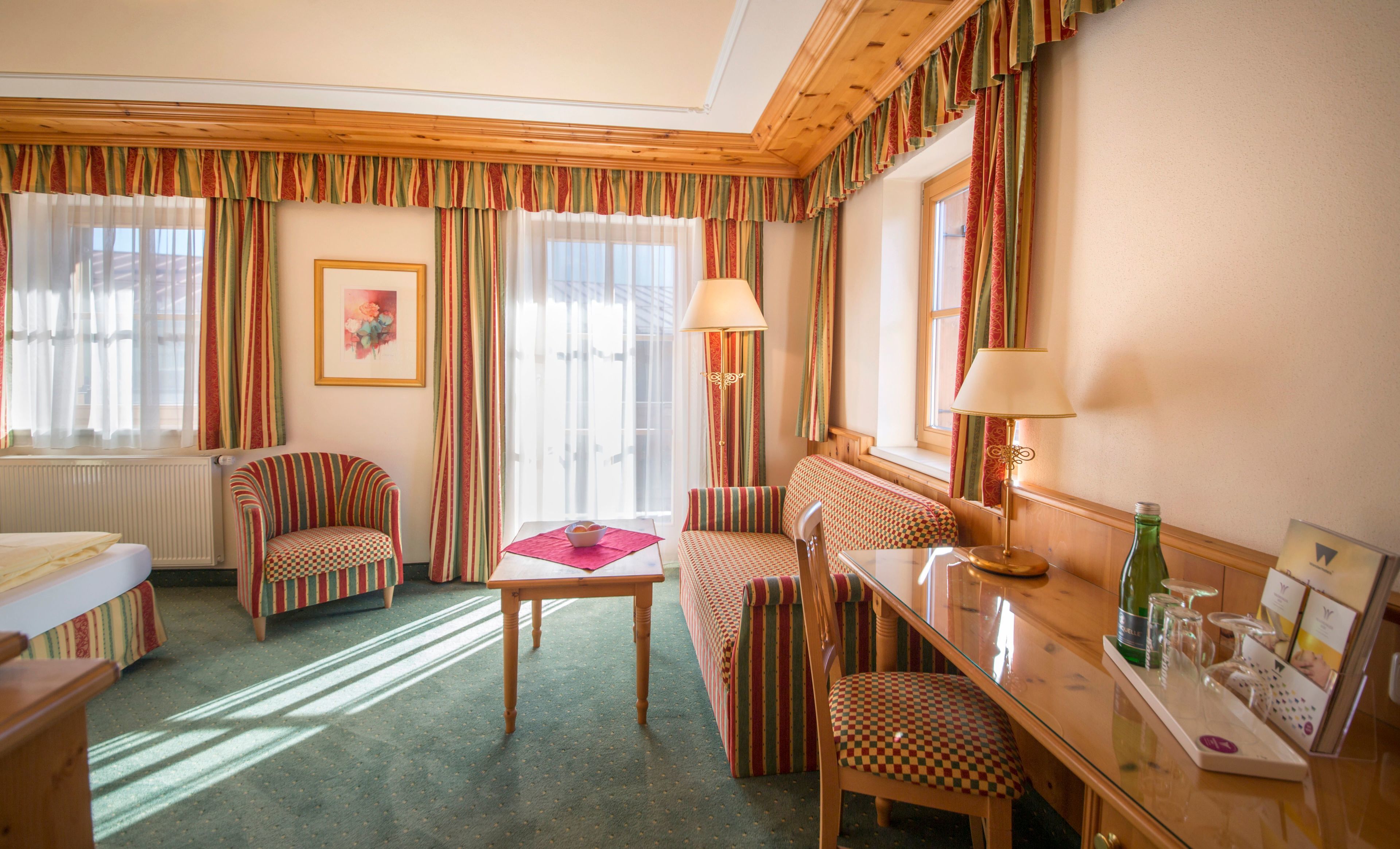 deluxe double room, balcony | living area | flat-screen tv