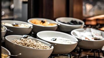 Un bufé de desayuno con diversas opciones de comida en cuencos.