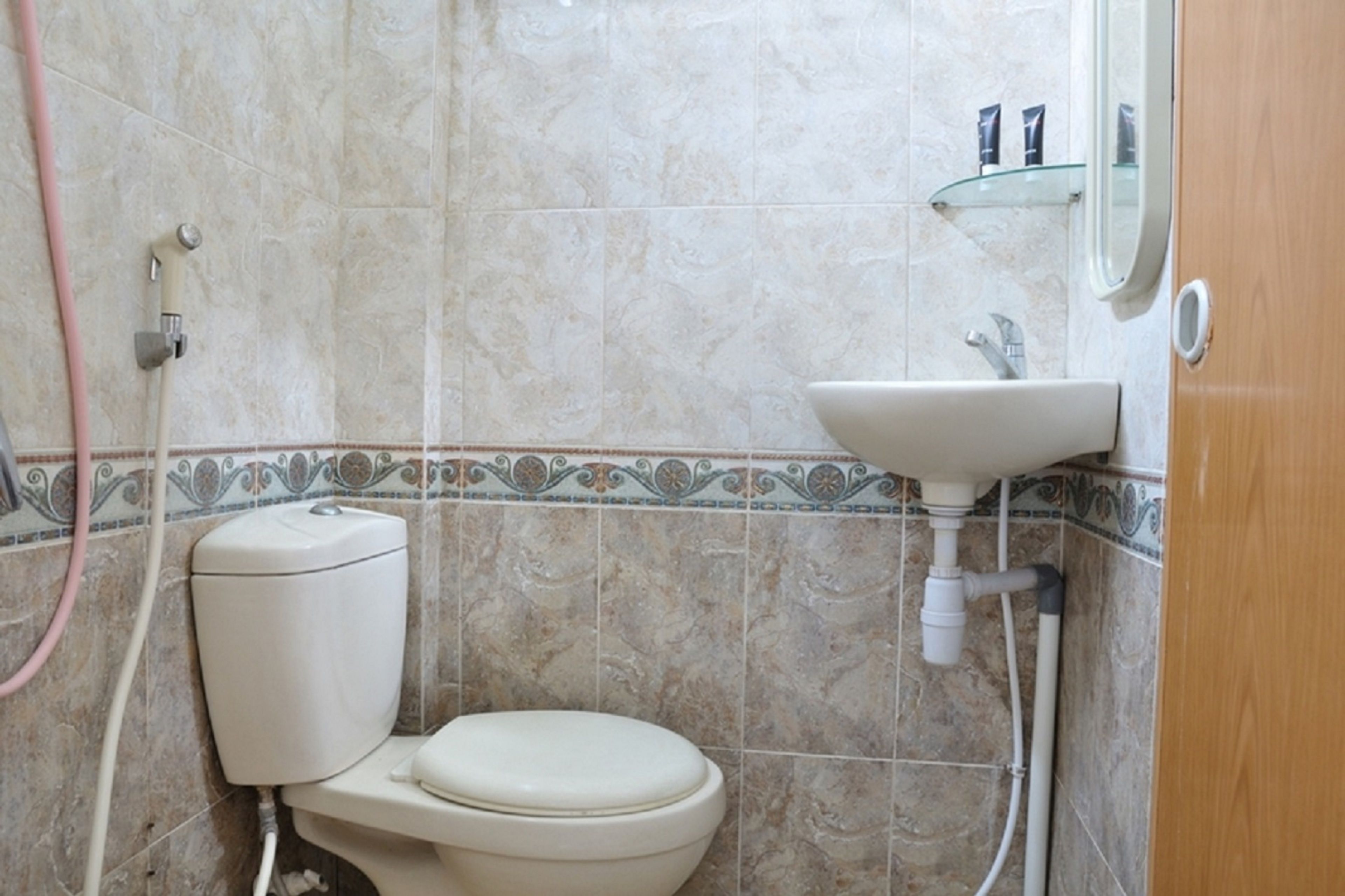 A bathroom with a toilet, sink, and shower.