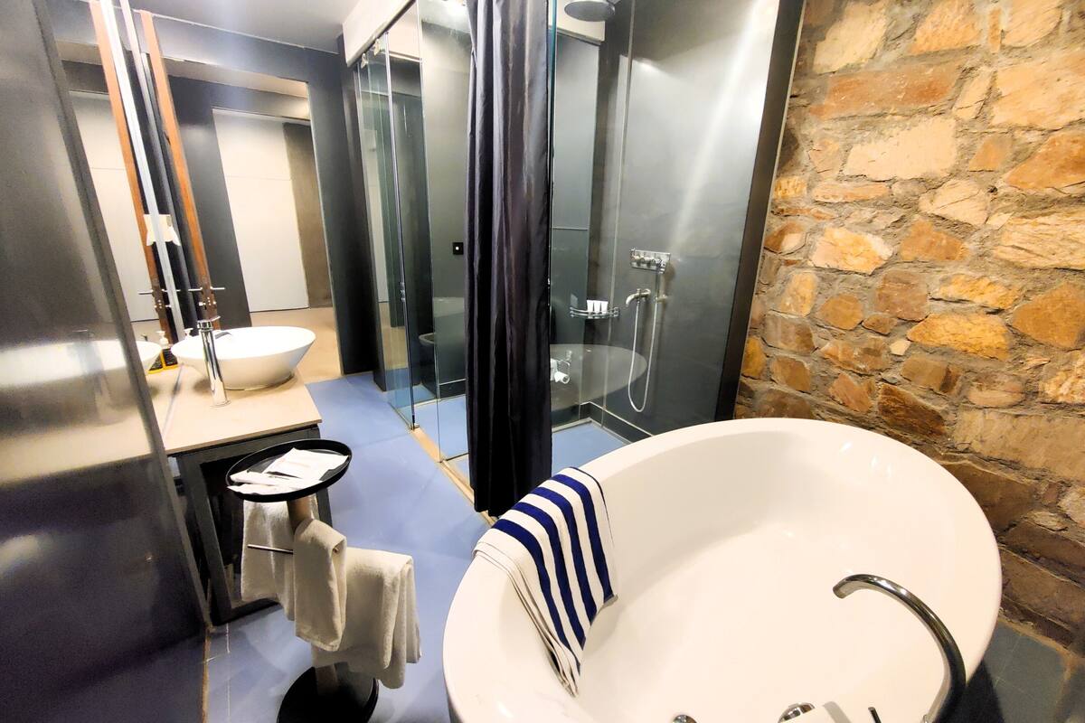 suite, 1 king bed | bathroom | rainfall showerhead, free toiletries, hair dryer, bathrobes