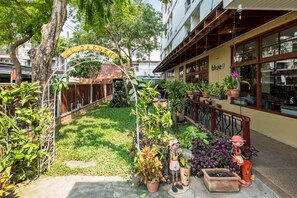 A courtyard with a sign reading "ST. GREGORY'S" and a building with a "blue9" sign. - JL Bangkok (Bangkok)
