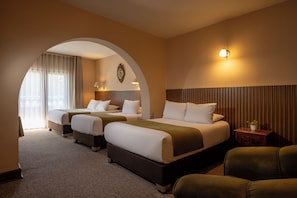 A hotel room with two beds, a sofa, a small table, and a lamp. - El Virrey at Plaza de Armas by Katari (Cusco)