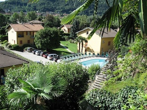 Outdoor pool, open 9:00 AM to 8:00 PM, pool umbrellas, pool loungers