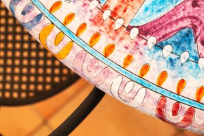 A close-up of a colorful, patterned object with a series of oval shapes and a blue line. - Poggio Aragosta Hotel & Spa (Casamicciola Terme)
