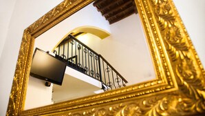 A staircase with a black railing and a golden ornate frame surrounding it. - Lindos Boutique Rooms - Adults Only (Rhodes)