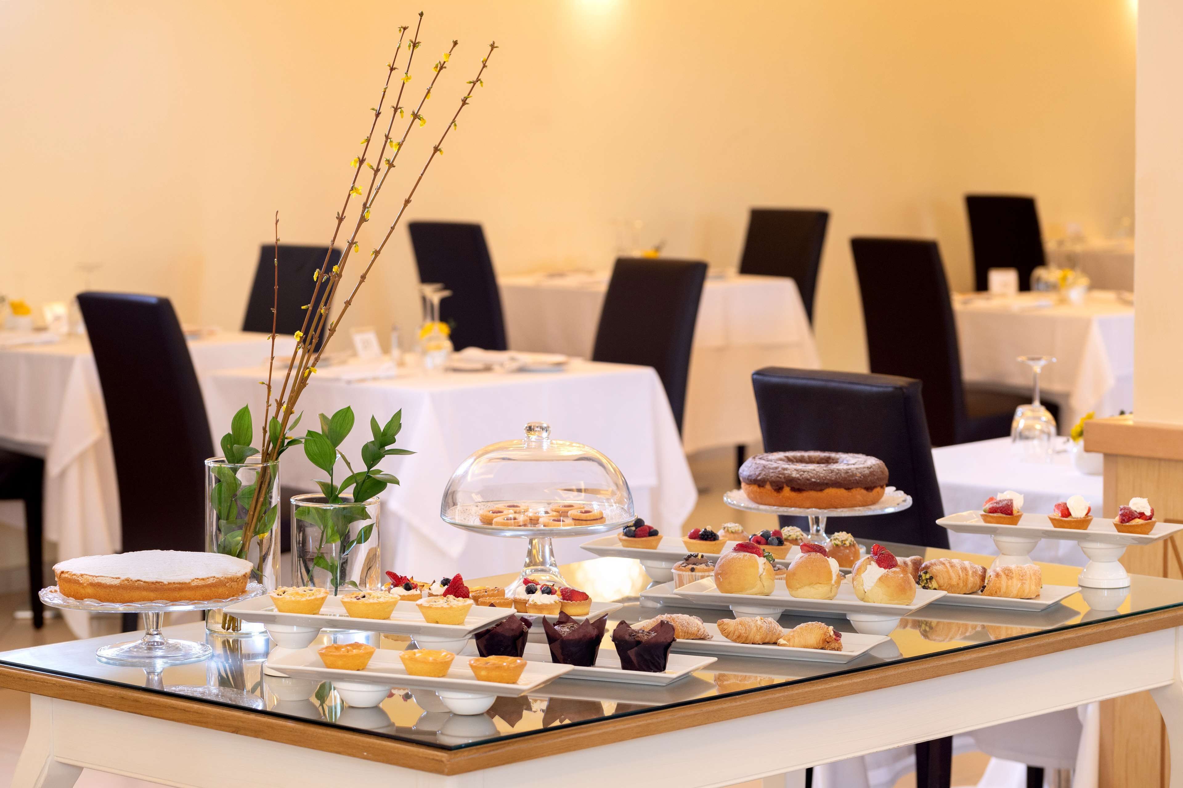 A buffet table with various pastries and desserts.