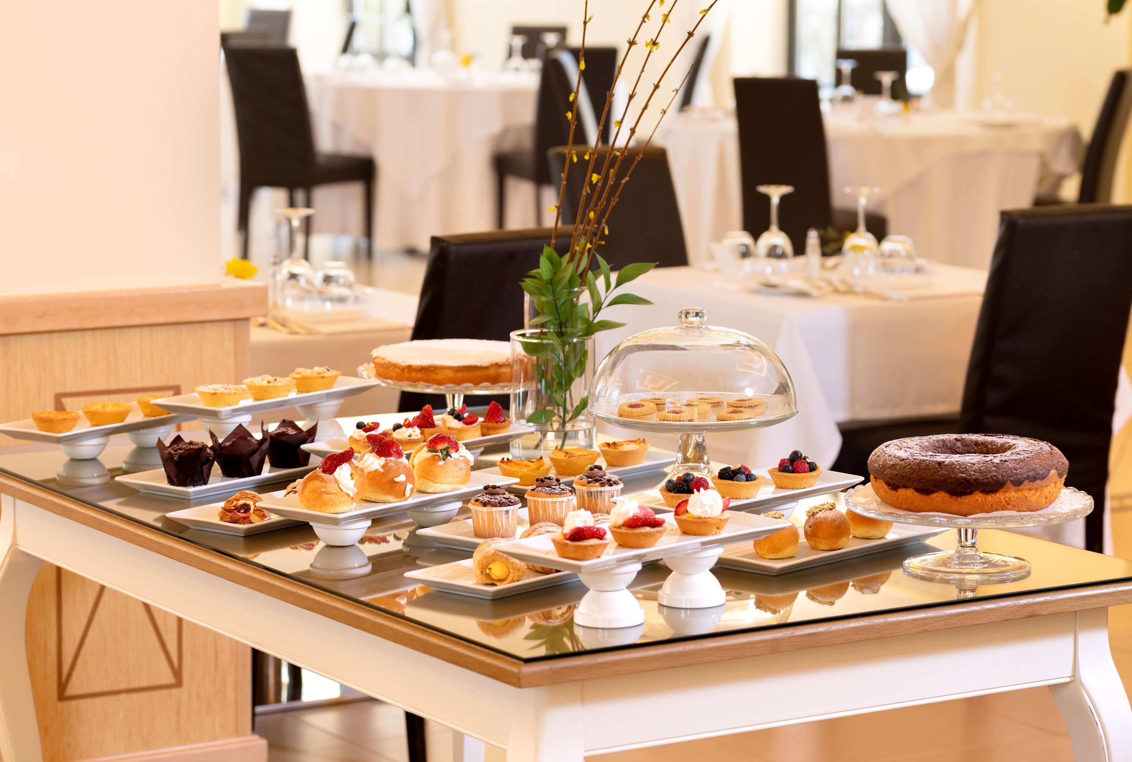 Una mesa de buffet con diversos postres y pasteles.