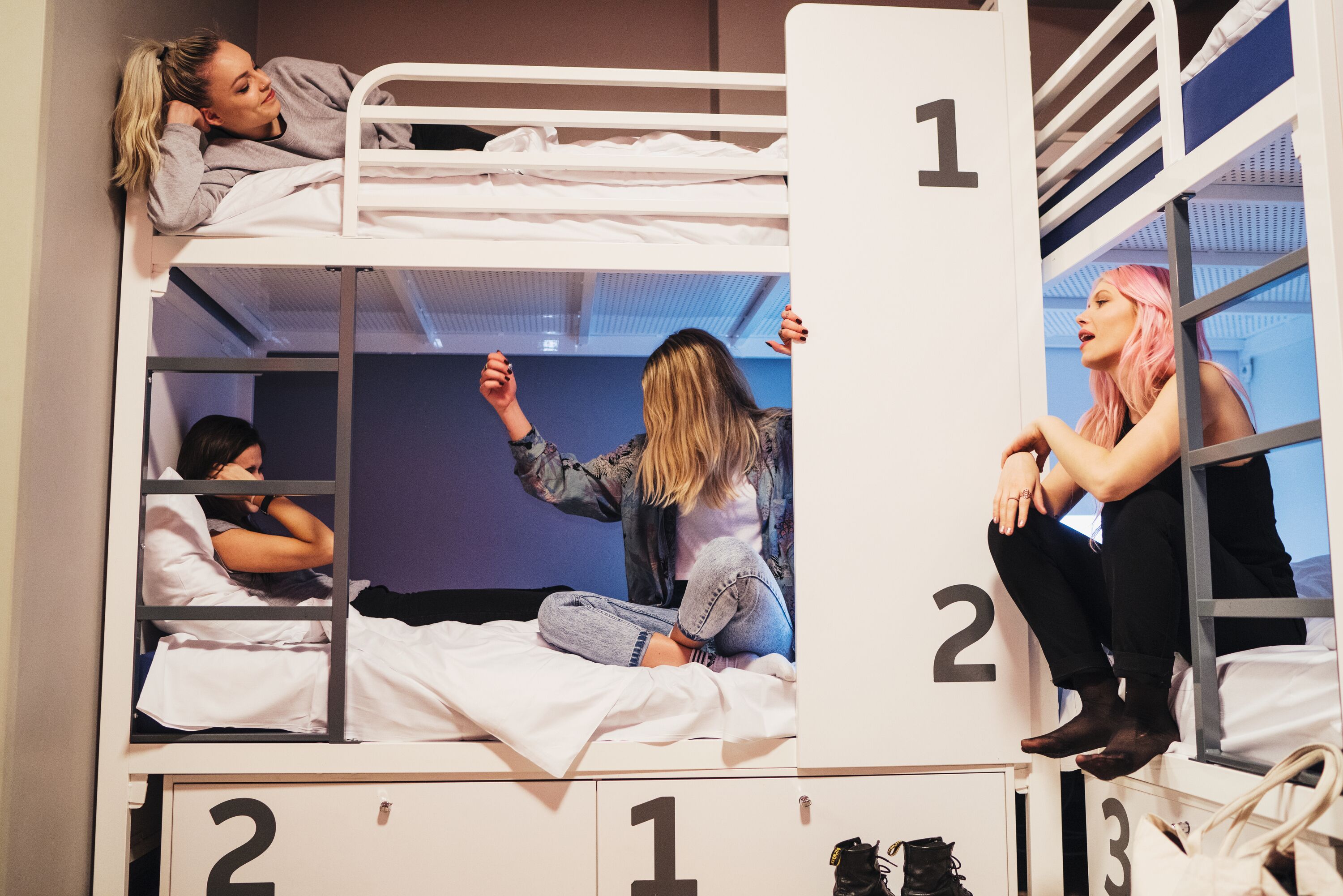 A bunk bed room with three levels, each marked with a number.