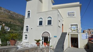 Ein zweistöckiges Gebäude mit einem Schild für 'Hotel Royal Hills'.