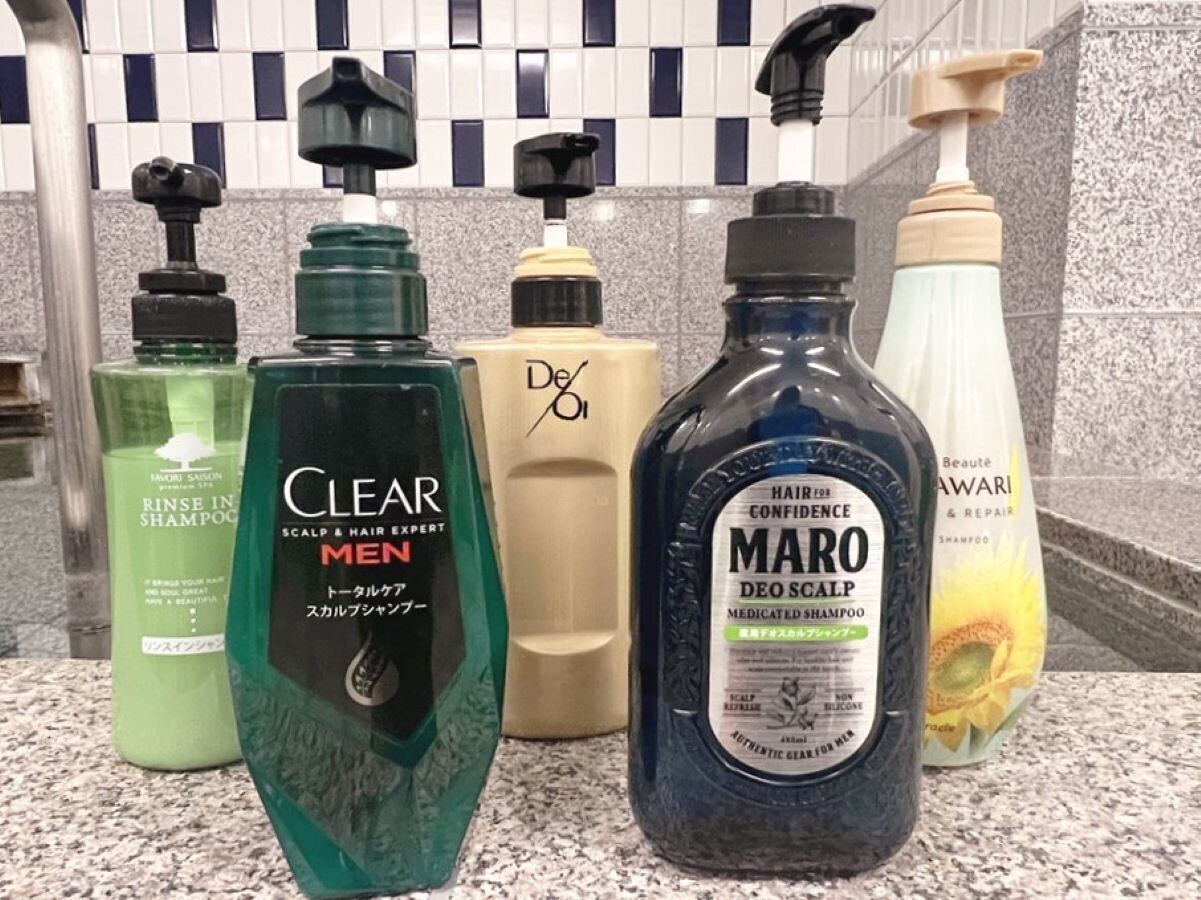 A bathroom counter with various hair care products.
