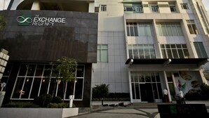 A tall, modern building with multiple floors and balconies. The building has a sign that reads "The Exchange Regency." - The Exchange Regency Residence Hotel (Pasig)