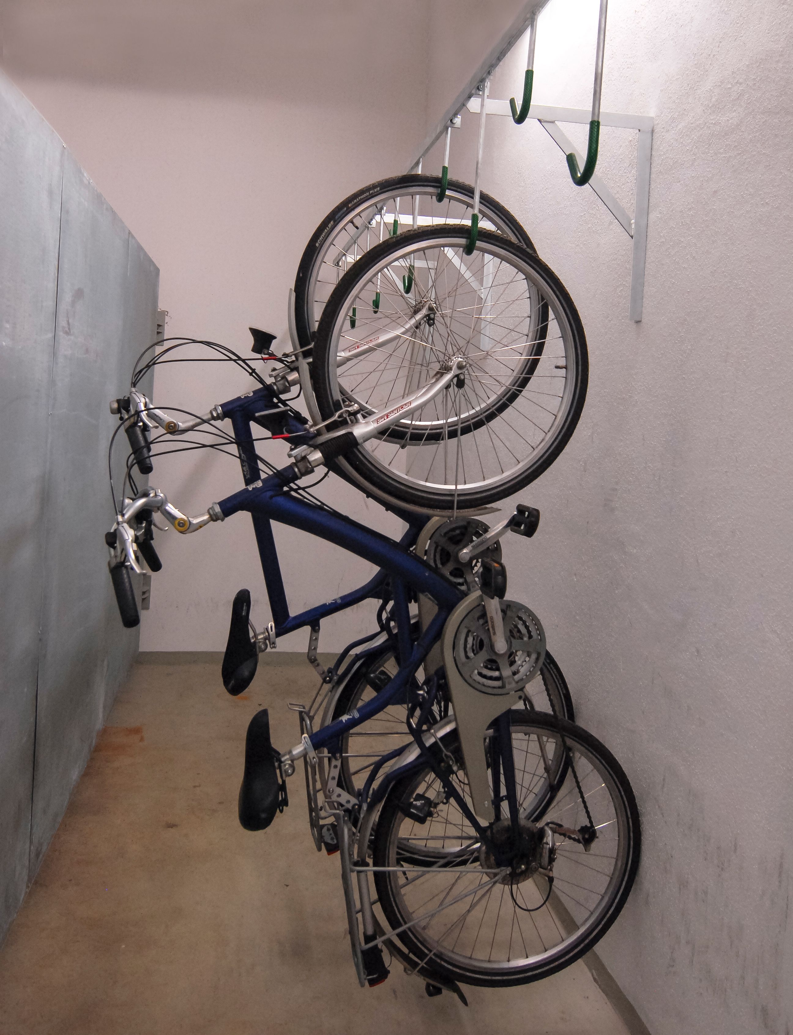 A bicycle rack with two bicycles secured to it.
