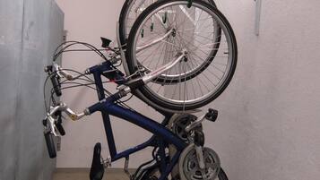 A bicycle rack with two bicycles secured to it.