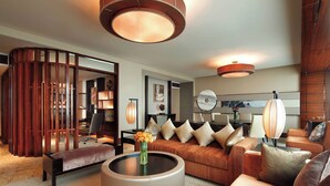 A modern living room with a round coffee table, a sofa set, and a wooden partition. - Sheraton Hefei Xinzhan Hotel (Hefei)