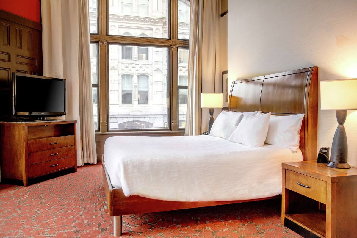 king bed corner room | premium bedding, in-room safe, desk, iron/ironing board