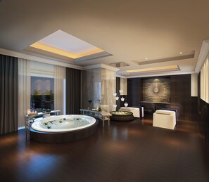 A modern bathroom with a large bathtub, a round seating area, and a wall-mounted light fixture. - The Langham, Shenzhen (Shenzhen)