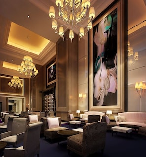 A spacious lobby with a large chandelier, comfortable seating, and a prominent floral artwork on the wall. - The Langham, Shenzhen (Shenzhen)