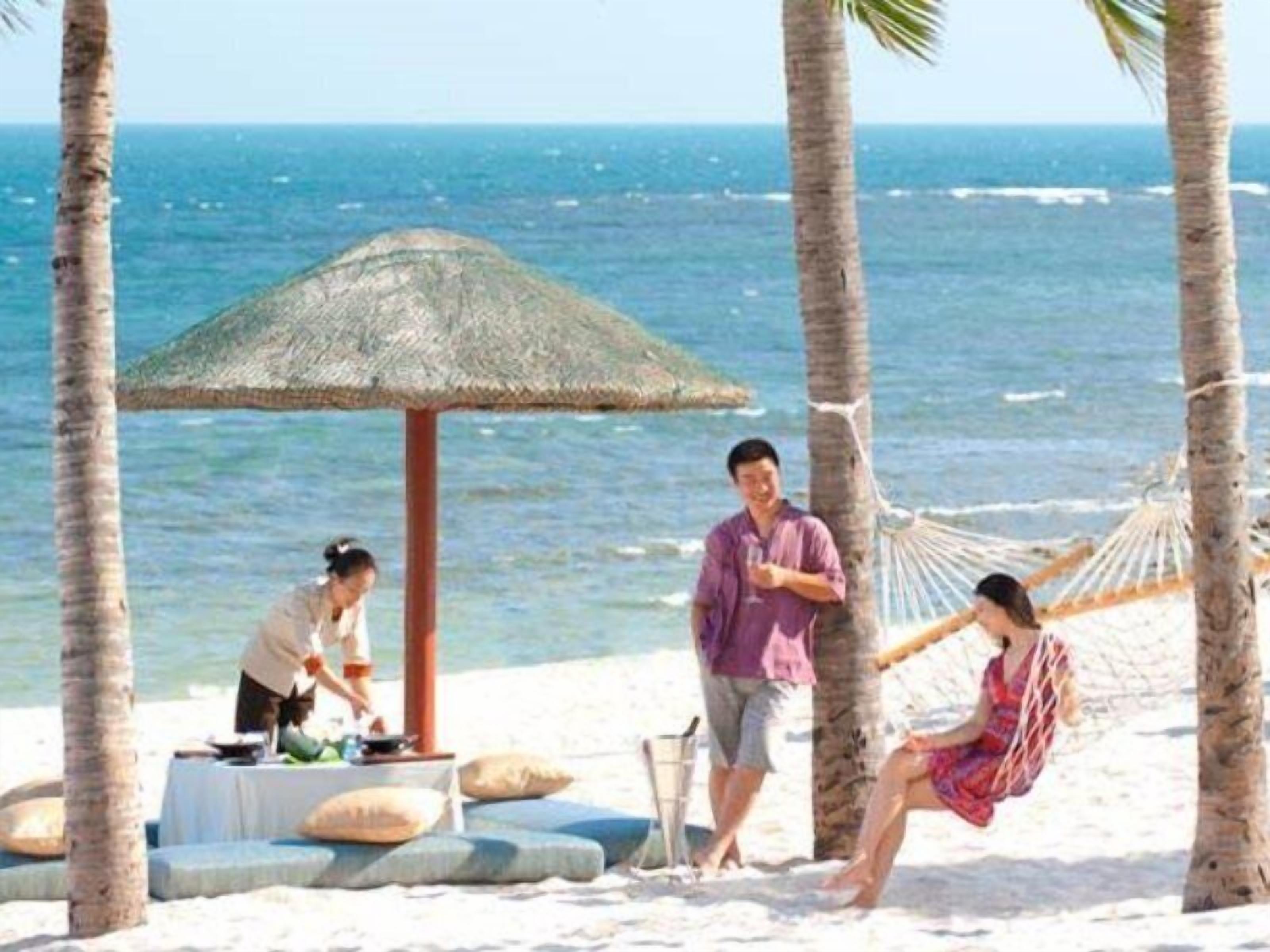 White sand, beach towels, beach volleyball