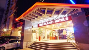 The exterior of Red Planet Hotels with a modern design, featuring a prominent entrance and a staircase leading up to the lobby. - Red Planet Makati Avenue Manila (Makati)