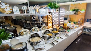 A buffet setup with various food stations, including a salad bar, a fruit station, and a hot food station. - One Pacific Place Serviced Residences (Makati)