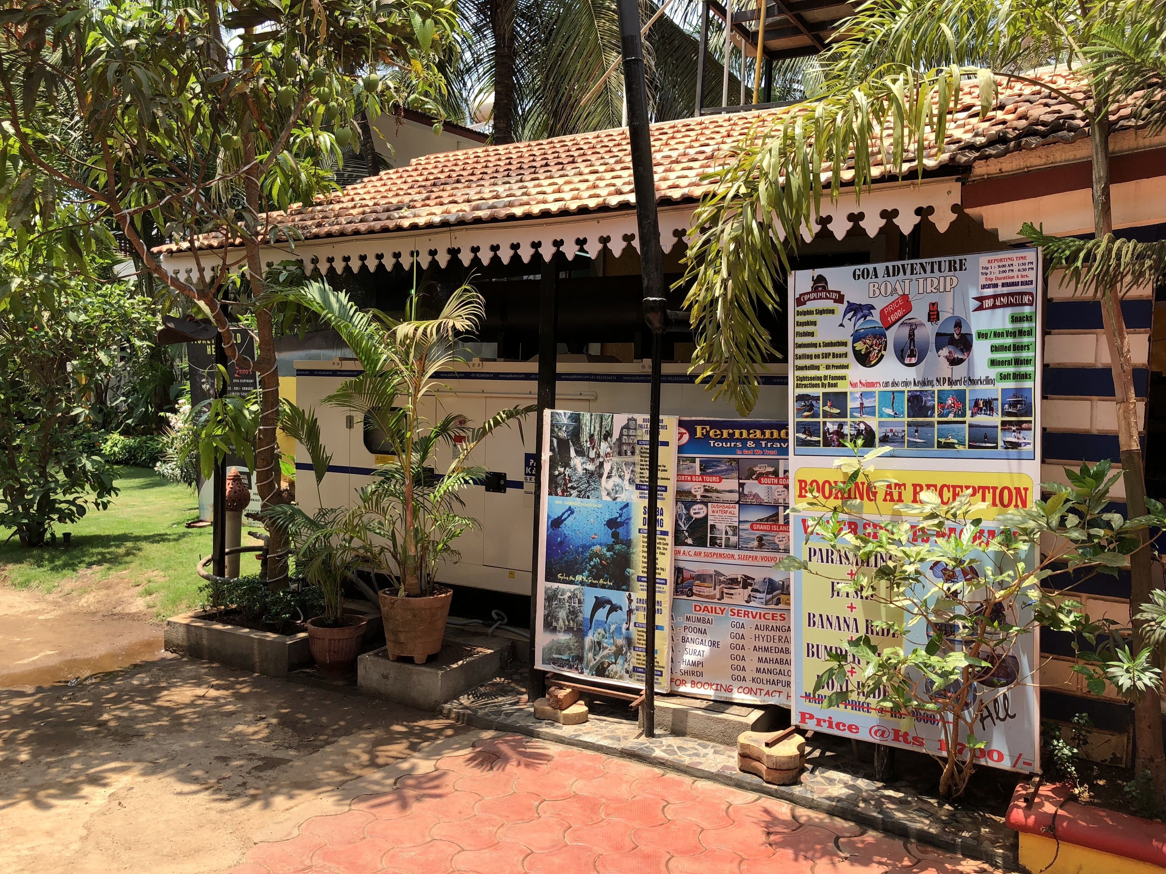 A travel agency with a tiled roof and multiple posters advertising tours and services.