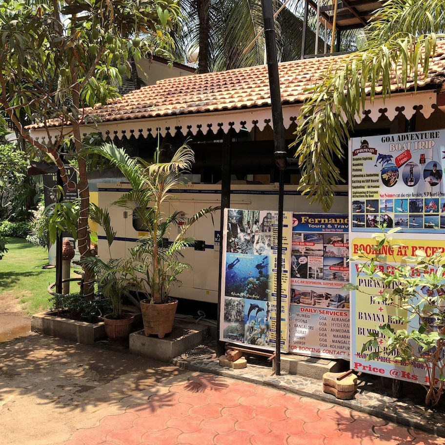 A travel agency with a tiled roof and multiple posters advertising tours and services.