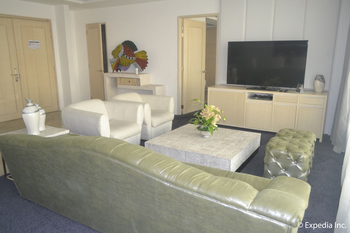 Penthouse, 1 King Bed | Living area | 40-inch LCD TV with cable channels, TV, DVD player