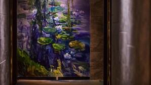 A large, framed painting of a pond with lilies and greenery. - Spring Time Hotel (Guangzhou)